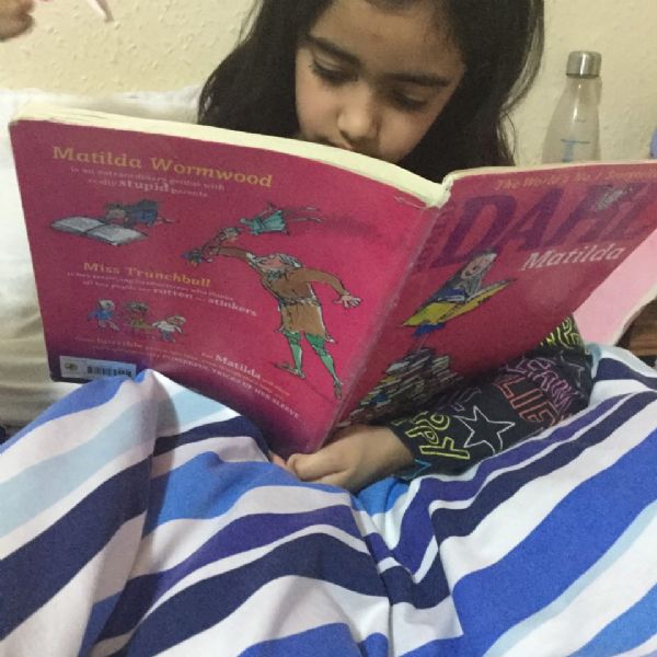 Aadhya reading the class novel 