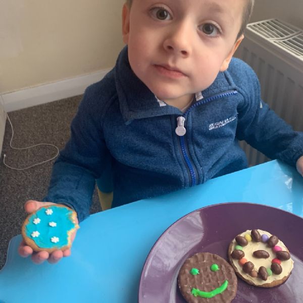 Fineas enjoying his decorated biscuits