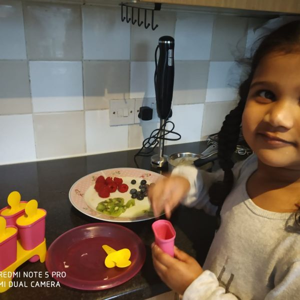 Zoey making fruit lollies